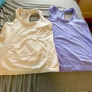 The brand is athleta, the sizes are one medium in white and the purple is large